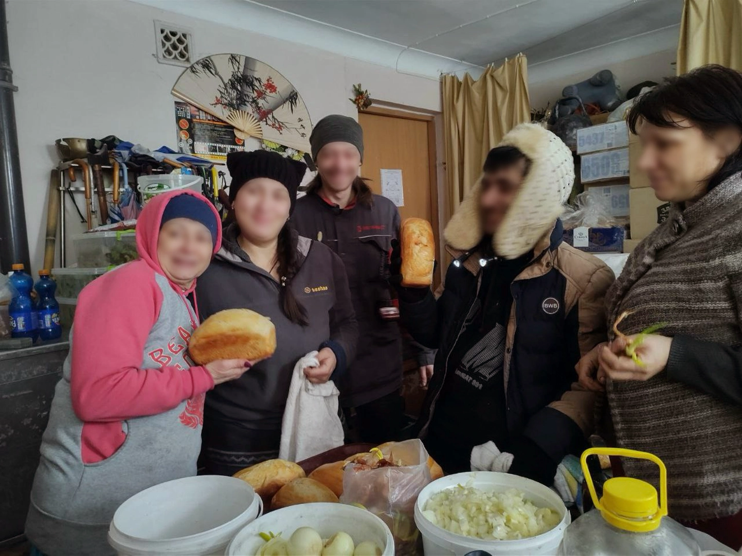 Volunteers prepare food for cooking in the field kitchen, a converted room for props. ©Yevheniia Zabohonska