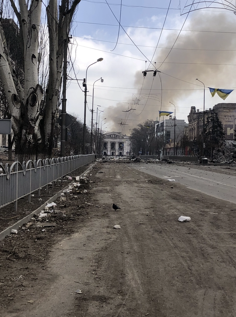 The facade of the Drama Theater after the attack. A column of smoke can be seen behind. ©Alevtyna Shvetsova